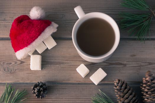 cup of coffee and sugar in Santa Claus cap