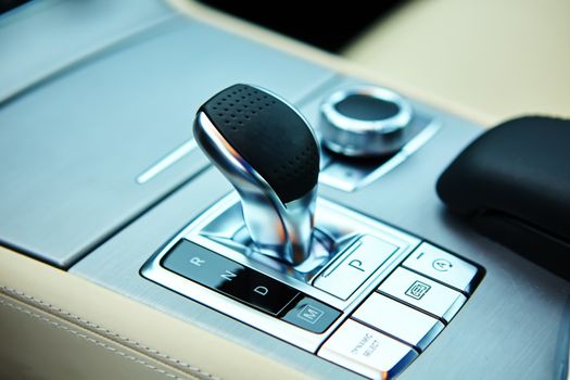 Detail of modern car interior, gear stick, automatic transmission in expensive car