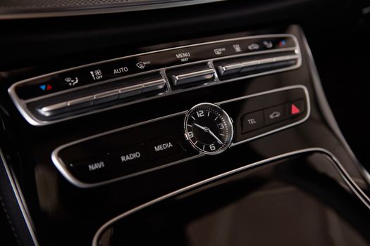 Luxury car interior details. Middle console with air and multimedia controls.