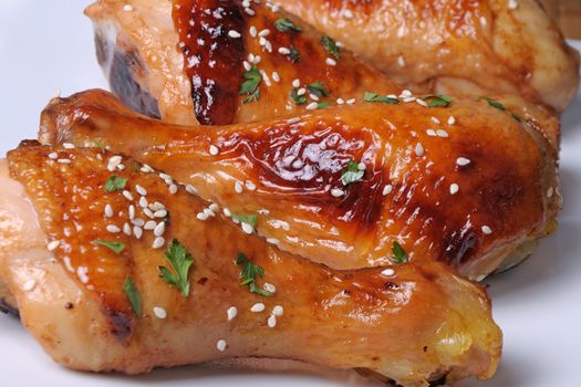 Fried chicken leg with sesame seeds in a plate closeup