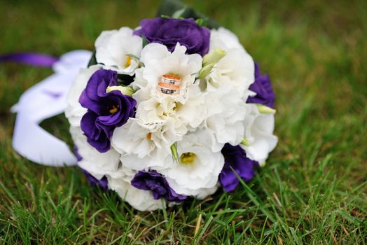 beautiful bridal bouquet lying on the grass.