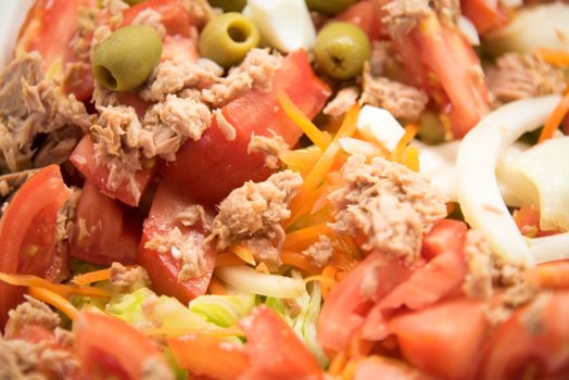 Salad with tuna and fresh vegetables .