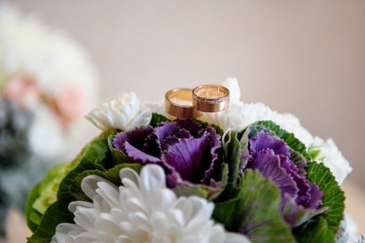 two golden rings on a wedding bouquet close up