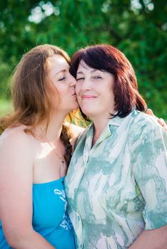 portrait of mother and daughter in summer sunny day