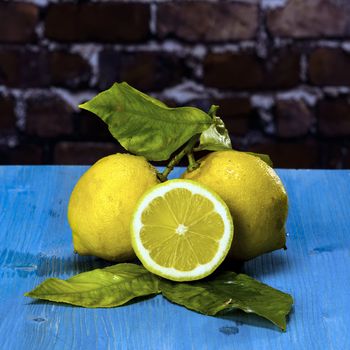 Acid and yellow fruit. Lemons on a blue wood, stock photo