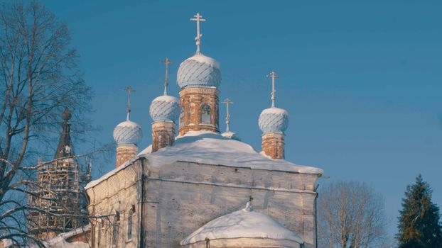 Old orthodox church in the country. Winter snowy day, 4K