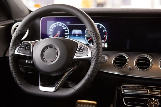 Luxury car Interior. Steering wheel and dashboard