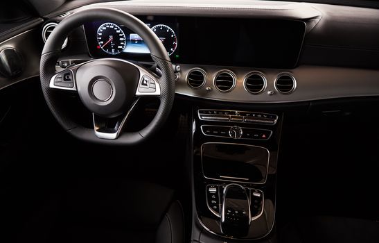 Luxury car Interior. Steering wheel and dashboard