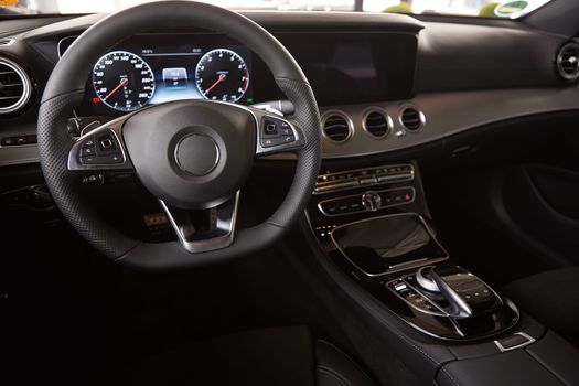 Luxury car Interior. Steering wheel and dashboard