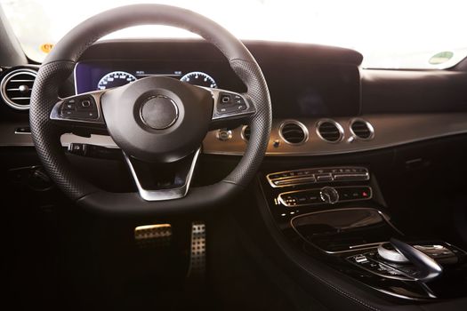 Luxury car Interior. Steering wheel and dashboard