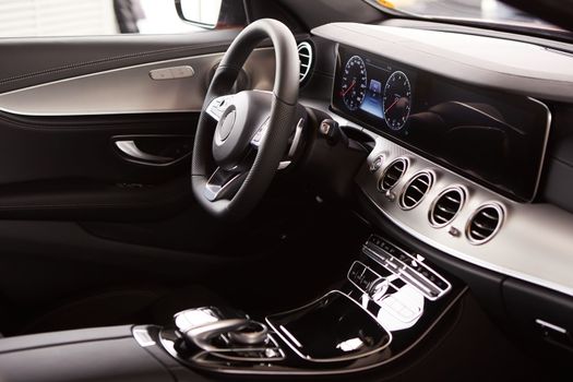 Luxury car Interior. Steering wheel and dashboard