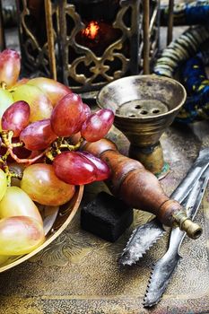 Hookah ,grapes and Arabic stylish lantern with candle