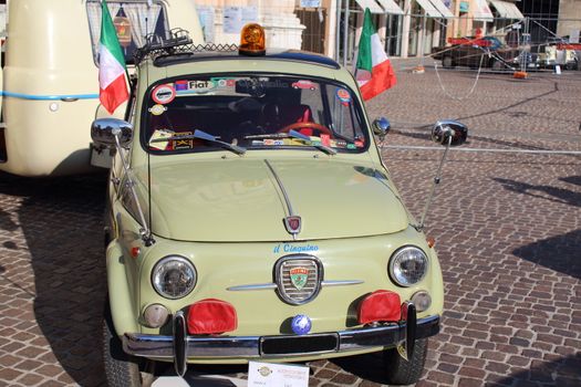 Ferrara, Italia - September 24, 2016: The event "AutoMotoStoriche in Old Town" you can admire an exhibition of cars and motorcycles in the historic center of Ferrara. Fiat 500 d with an attached trailer Laika