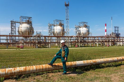 Smiling refinery woman worker on petrochemical factory