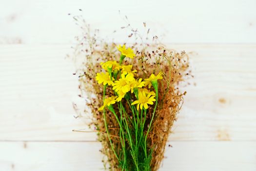 Bouquet of Yellow Daisies on the Table wood