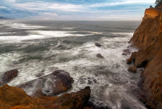 Surfer on the Pacific Ocean at Cape Kiwanda in Pacific City Oregon Coast