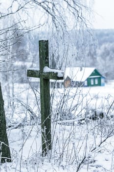 Old cemetery at abandoned  village in a winter day