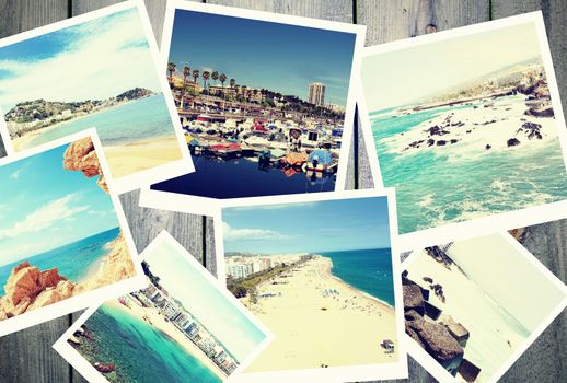 Heap of the vintage photos from summer holiday with traditional white frame placed on wooden desk.