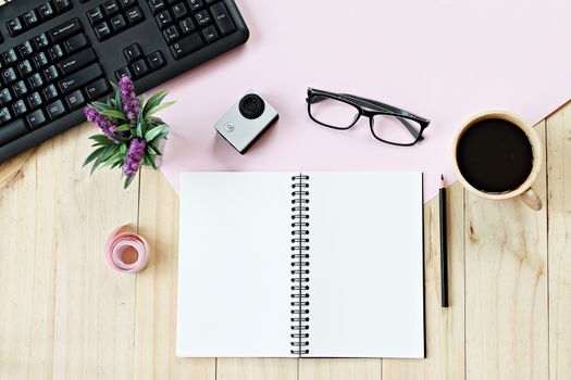 Business concept : Flat lay style of office workspace desk with blank notebook paper, computer keyboard, cup of coffee and accessories, top view mock up