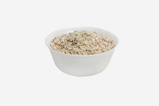 Bowl of oats porridge isolated on a white background Healthy breakfast