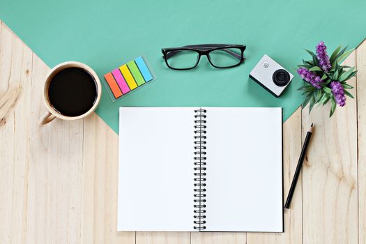 Business concept : Flat lay style of office workspace desk with blank notebook paper, cup of coffee and accessories, top view mock up