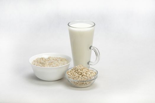 Bowl of oats porridge isolated on a white background Healthy breakfast