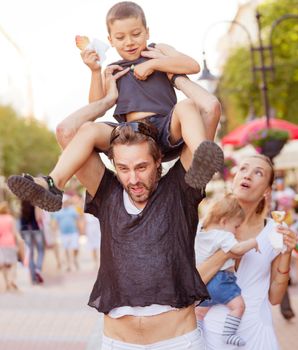 A young couple is struggling while trying to entertain their two boys.