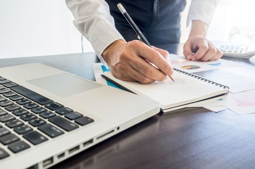 Business, office concept. businessman working with digital tablet and laptop with financial business document.