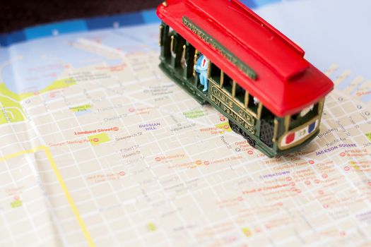 Wooden cable car miniature on the blurred map of San Francisco