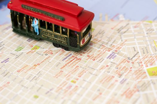 Wooden cable car miniature on the blurred map of San Francisco
