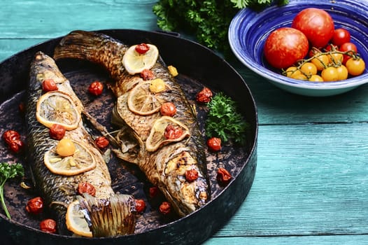 Whole baked fish in tomatoes,lemon and spices