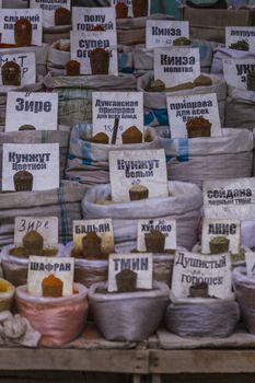 Beautiful vivid oriental market with bags full of various spices in Osh bazaar in Bishkek, Kyrgyzstan.