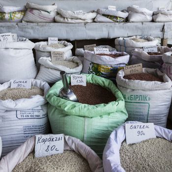 Spices and vegetables in bags at local bazaar in Osh. Kyrgyzstan.