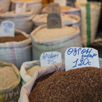 Spices and vegetables in bags at local bazaar in Osh. Kyrgyzstan.