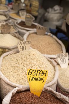 Spices and vegetables in bags at local bazaar in Osh. Kyrgyzstan.