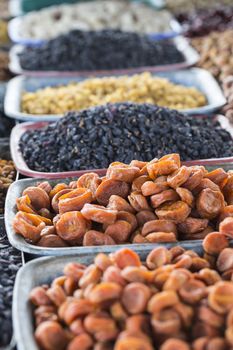 Dry fruits and spices like cashews, raisins, cloves, anise, etc. on display for sale in a bazaar in Osh Kyrgyzstan.