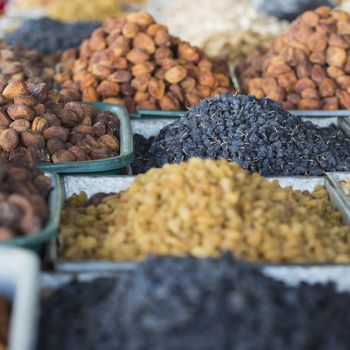 Dry fruits and spices like cashews, raisins, cloves, anise, etc. on display for sale in a bazaar in Osh Kyrgyzstan.