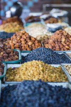 Dry fruits and spices like cashews, raisins, cloves, anise, etc. on display for sale in a bazaar in Osh Kyrgyzstan.