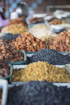 Dry fruits and spices like cashews, raisins, cloves, anise, etc. on display for sale in a bazaar in Osh Kyrgyzstan.