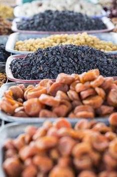 Dry fruits and spices like cashews, raisins, cloves, anise, etc. on display for sale in a bazaar in Osh Kyrgyzstan.