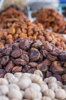 Dry fruits and spices like cashews, raisins, cloves, anise, etc. on display for sale in a bazaar in Osh Kyrgyzstan.