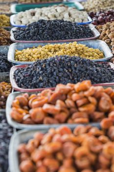 Dry fruits and spices like cashews, raisins, cloves, anise, etc. on display for sale in a bazaar in Osh Kyrgyzstan.