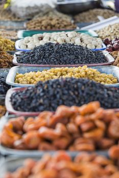 Dry fruits and spices like cashews, raisins, cloves, anise, etc. on display for sale in a bazaar in Osh Kyrgyzstan.