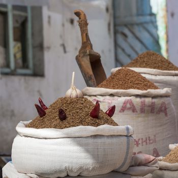 Spices and vegetables in bags at local bazaar in Osh. Kyrgyzstan.