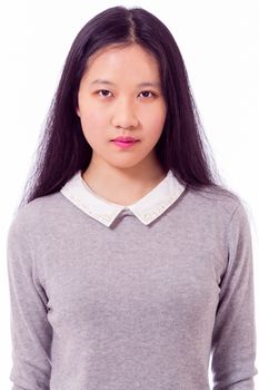 Portrait of Chinese teenage girl looking at camera, serious expression