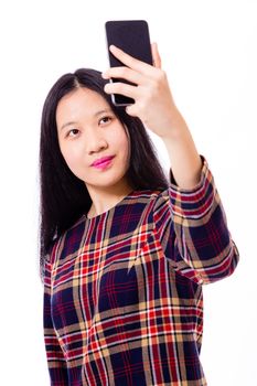 Chinese teenage girl in plaid dress taking selfie with smartphone