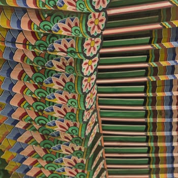 Detail of Traditional Korean Roof, Colourful Decorated Ornament for Ancient Korean Palace or Temple at Seoul, South Korea.