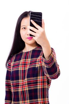 Chinese teenage girl in plaid dress taking selfie with smartphone