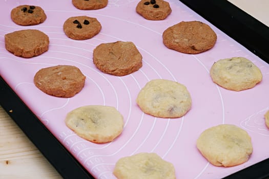 Cookies in baking tray on the table Wood