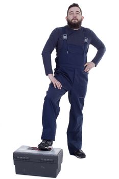 Bearded man mechanic with tool box on a white background